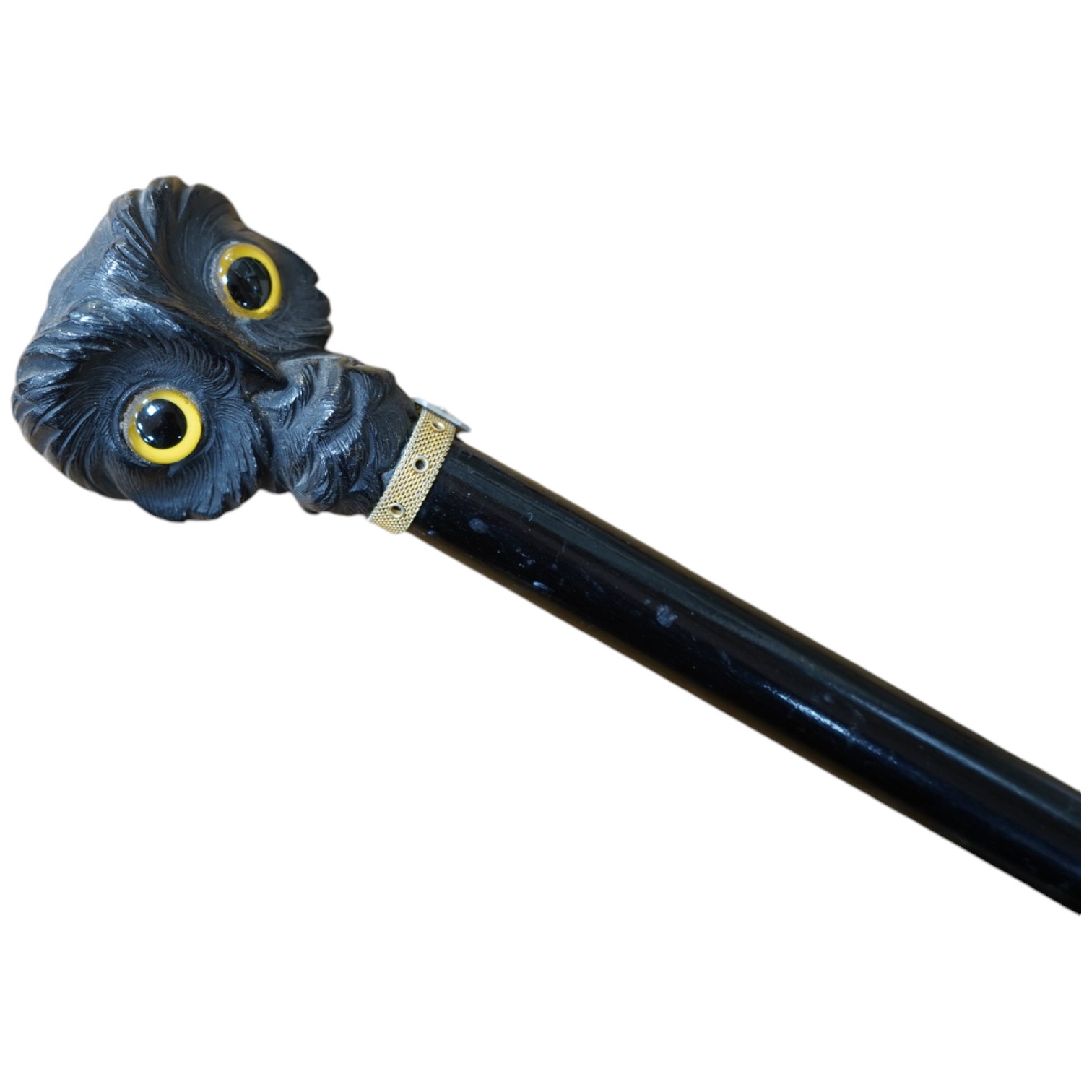 A Victorian ebony 'owl's head' walking stick, 85cm long. Condition - good.